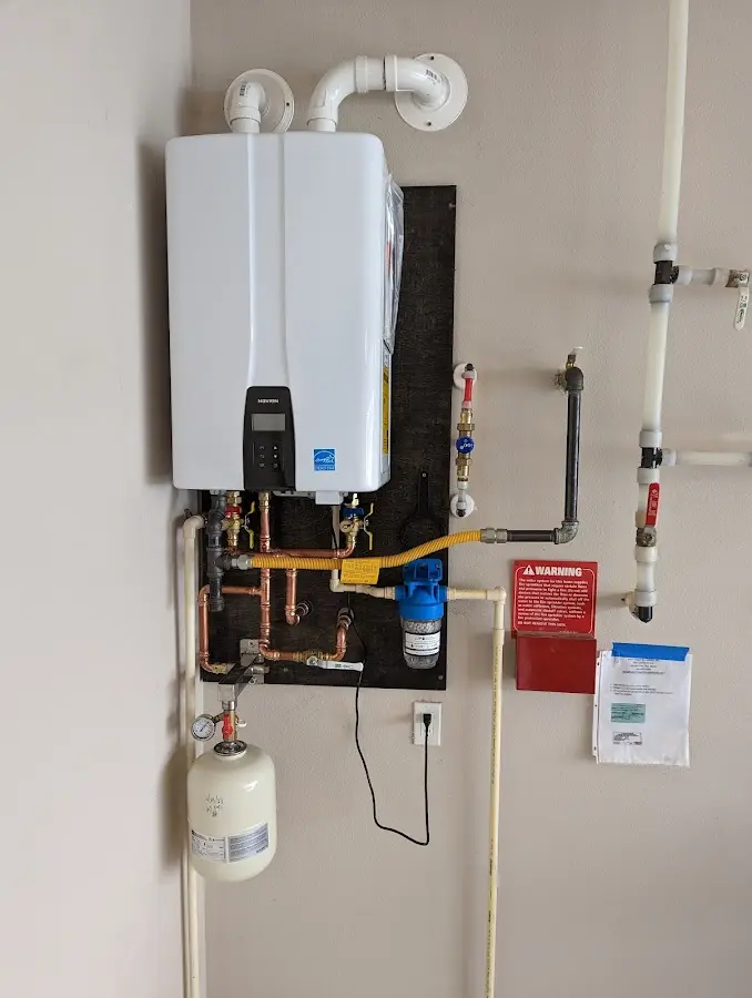 Professional plumber installing copper piping in a Pennsauken home